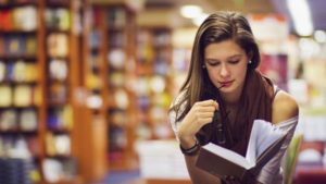 Girl-reading-at-library